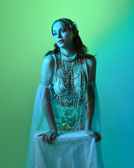 Fantasy studio portrait of a red-haired mermaid faery model wearing white pearl gown, fairytale...