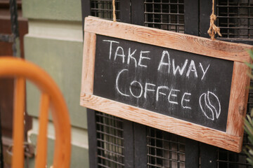 Coffee takeaway sign outside a cozy cafe in the city