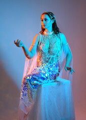 Fantasy studio portrait of a red-haired mermaid faery model wearing white pearl gown, fairytale...