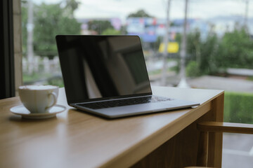 Laptop and coffee on the table. Work from home concept.