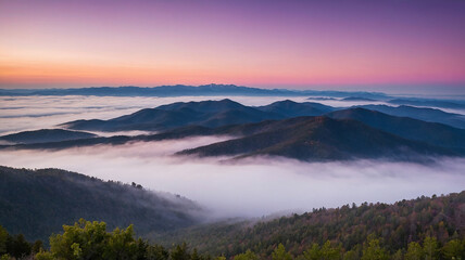 Majestic mountain sunrise over foggy valley