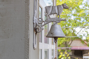 Rustic Farmhouse Doorbell with Cow Design on Sunny Day