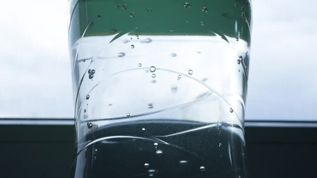 Closeup Blurred Shooting with Bubbles from a Botle with Accidulated Sweet and Fresh Drink.