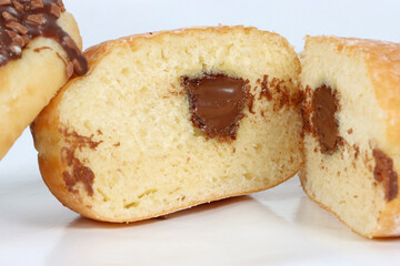 Chocolate-filled doughnut isolated on a white background. A soft pastry with a rich, creamy center