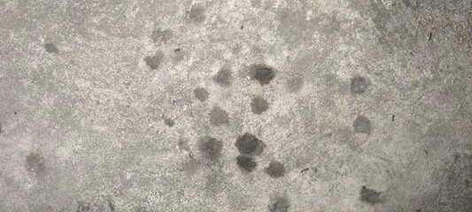 Stains of engine oil from cars that drip onto the floor in the parking lot