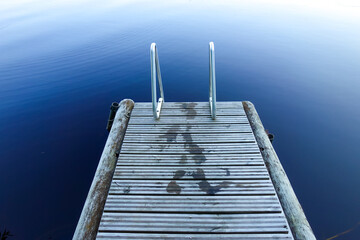 Wet footprints on wooden jetty