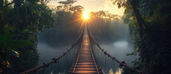 Fototapeta premium Sunrise Suspension Bridge Through Lush Jungle