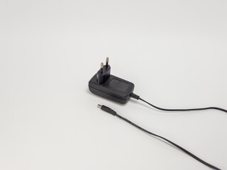 Black power adapter with cable isolated on a plain white background