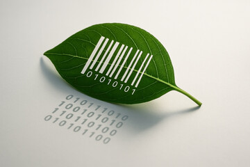 A single green leaf with printed white barcode accompanied by the digits “01010101" - Generative AI
