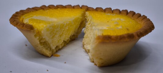 Egg tarts that are crispy on the outside and soft on the inside. Egg tarts that have a rich and creamy egg aroma. Egg tarts on white background.