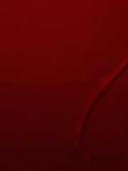 A solid red backdrop with two folds in it.