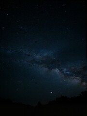 A stunning shot of stars shining brightly in the night sky. The Milky Way can also be seen on this photo.