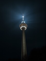 Obraz premium A tower with a light shining from top of it.