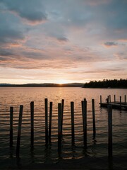 Fototapeta premium A view of water and poles at sunset.