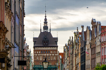View of a historic street in Gdańsk leading toward the Golden Gate – an impressive structure...