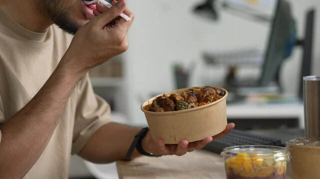 Man eating healthy meal while working, Businessman having a lunch break at the office