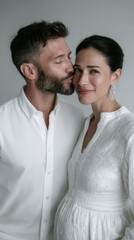 The photo shows a man kissing the belly of his pregnant wife.