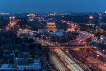 Yongdingmen City Tower at night in Beijing, China, with vehicle flow, traffic, and urban nightlife