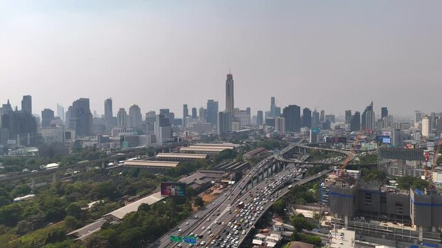 Aerial motion back shot of Bangkok cityscape and Sirat Expressway Traffic