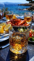 A table with a glass of liquor and a plate of food