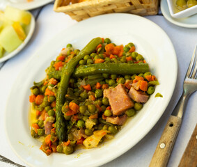 Image of stewed different vegetables and bacon served at plate