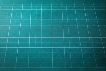 Close-up of teal cutting mat with white grid lines softly illuminated, showing textured surface and subtle shadows