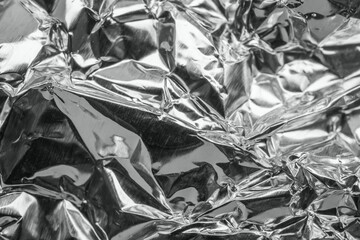 Shiny metal silver gray foil leaf crumpled texture background