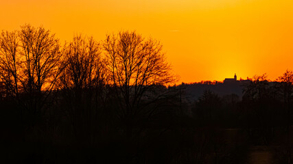 Fototapeta premium Sunset or sundowner with a church silhouette seen from near Mount Bogenberg, Bogen, Danube, Straubing-Bogen, Bavaria, Germany