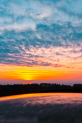 Sunset or sundowner with reflections on a car roof at Eichendorf, Dingolfing-Landau, Bavaria, Germany