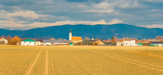 Spring landscape on a sunny day with Haardorf and the Bavarian Forest in the background seen from near Osterhofen, Deggendorf, Bavaria, Germany