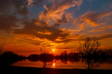 Spring sunset or sundowner view with reflections near Plattling, Isar, Deggendorf, Bavaria, Germany