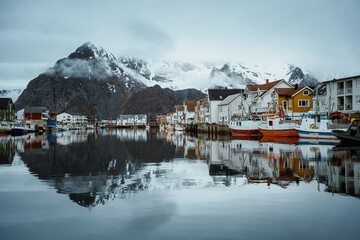 Fishing village of Henningsvaer with snowy mountain backdrop