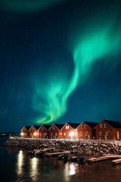 Northern Lights Over Red Cabins in Leknes, Lofoten