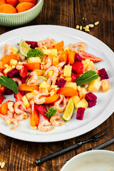 Salad with tropical fruits and shrimps.