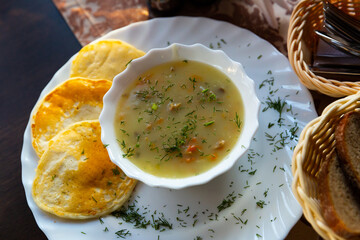 Machanka - stew with various types of meat, vegetables, mushrooms, sour cream and flour served with pancakes. Belarusian cuisine..