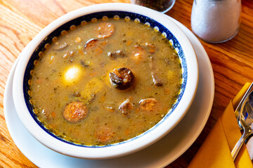 Zurek staropolski - old Polish style sour rye soup served with sausage and egg. High quality photo