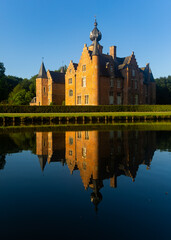 Obraz premium Reflection of Rumbeke Castle in water on summer day located in Rumbeke in West Flanders, Belgium