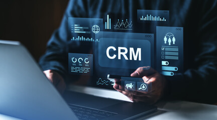 CRM system interface with futuristic digital analytics and user data charts on virtual screen in business technology environment concept.