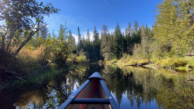Flipped time-lapse footage of a canoe gliding through a winding river in Temagami, Ontario, Canada