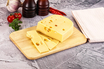 Maasdam cheese piece with slices