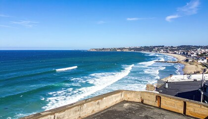 Fototapeta premium Coastal City Rooftop View of Waves and Horizon Over the Ocean