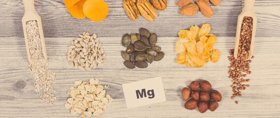 Inscription Mg, healthy food and various ingredients as source natural magnesium and other vitamins and minerals