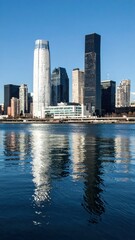 Obraz premium Reflections of Modern City Skyline Over Calm River Waters