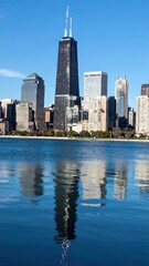 Obraz premium Stunning City Skyline with Strong Reflections in Calm River Waters