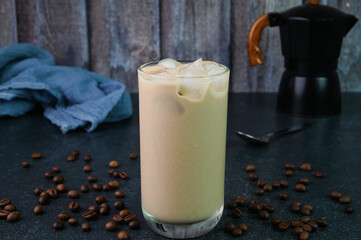 Iced coffee served in a glass cup.