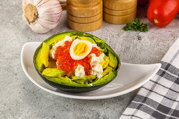 Avocado with red caviar and quil egg