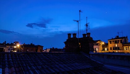 Obraz premium Rooftop View Under Deep Blue Sky with Artificial Lights at Blue Hour
