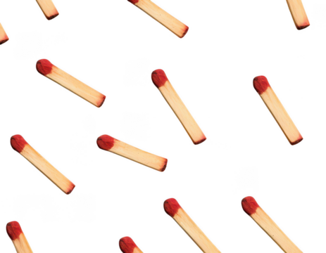 the image shows a dark background with several objects spread across the frame. these objects have a reddish brown tip and a light beige body that appears to be made of wood