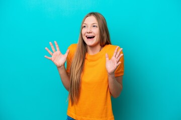 Young Russian woman isolated on blue background with surprise facial expression
