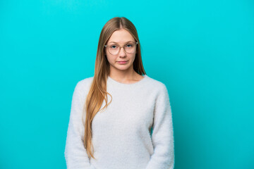 Fototapeta premium Young Russian woman isolated on blue background with sad expression